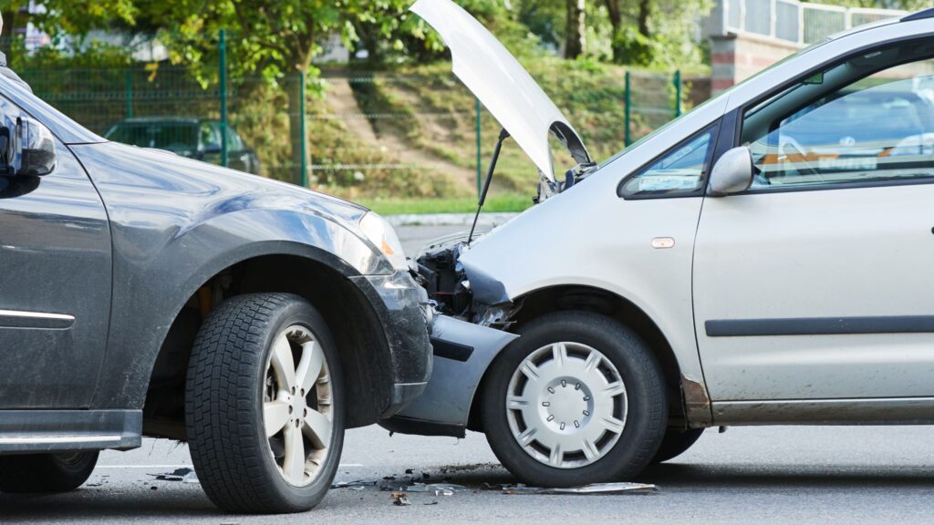 A head-on collision between two vehicles with visible damage, representing a case for a Gulfport Head-On Collision Lawyer from Haug, Farrar, Franco & Ruiz, PLLC.